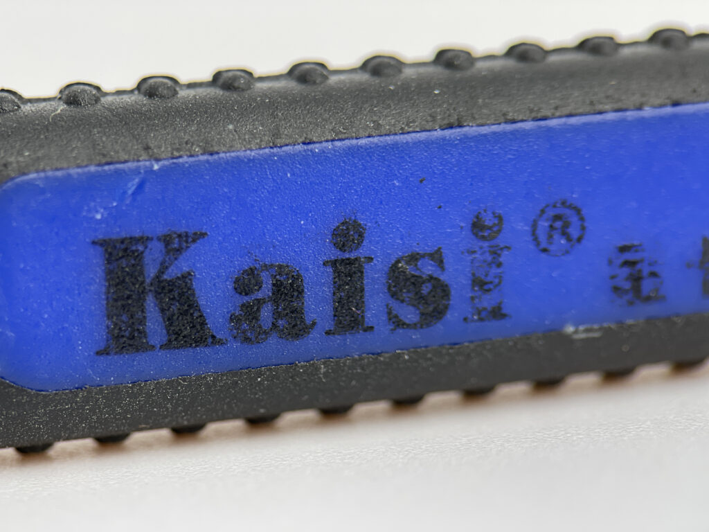 Close-up of OriGlam spudger pry tool with logo, ergonomic grip, ideal for electronic repairs.